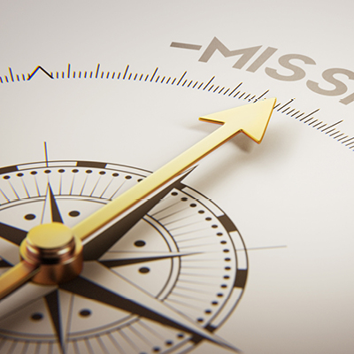 A compass where the arrow is pointing to the word "Mission"